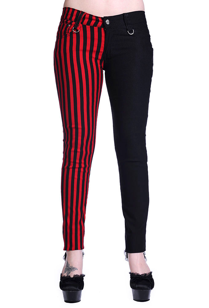 Low rise skinny jeans with one black leg and one black and red striped leg