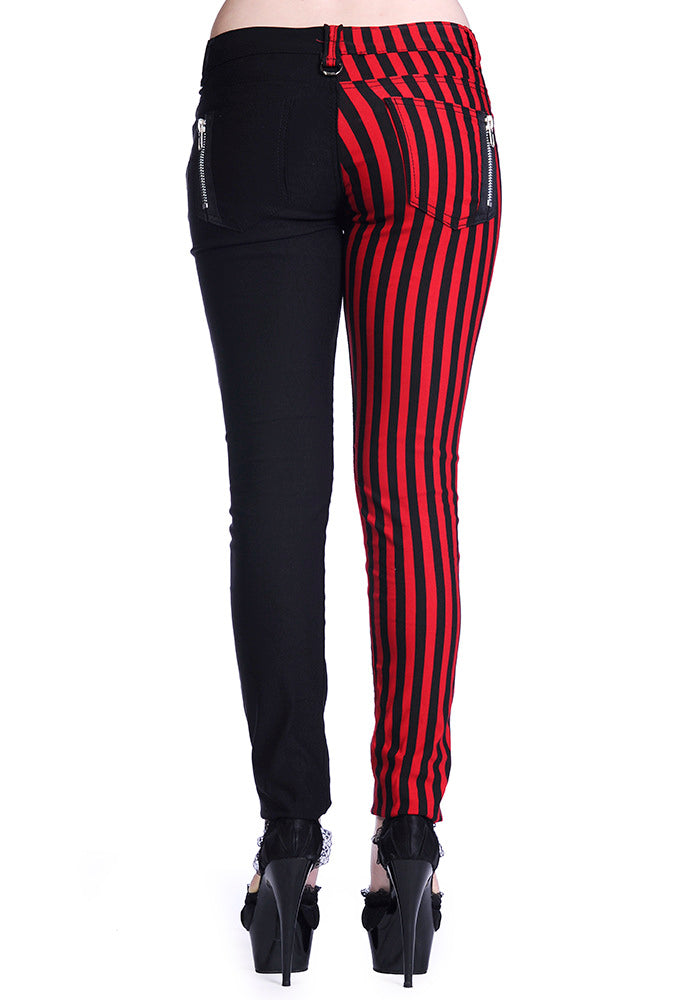 Low rise skinny jeans with one black leg and one black and red striped leg