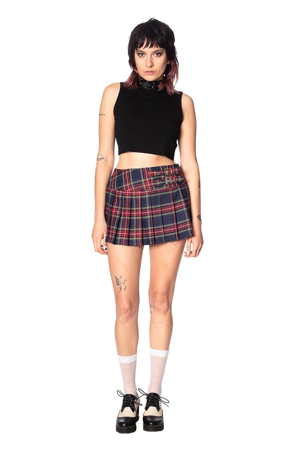 Alternative model in navy and red tartan skirt with crop top and white socks