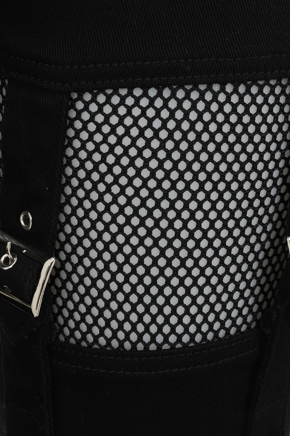 Mid rise black trousers with black mesh cut outs on the thighs and strap details