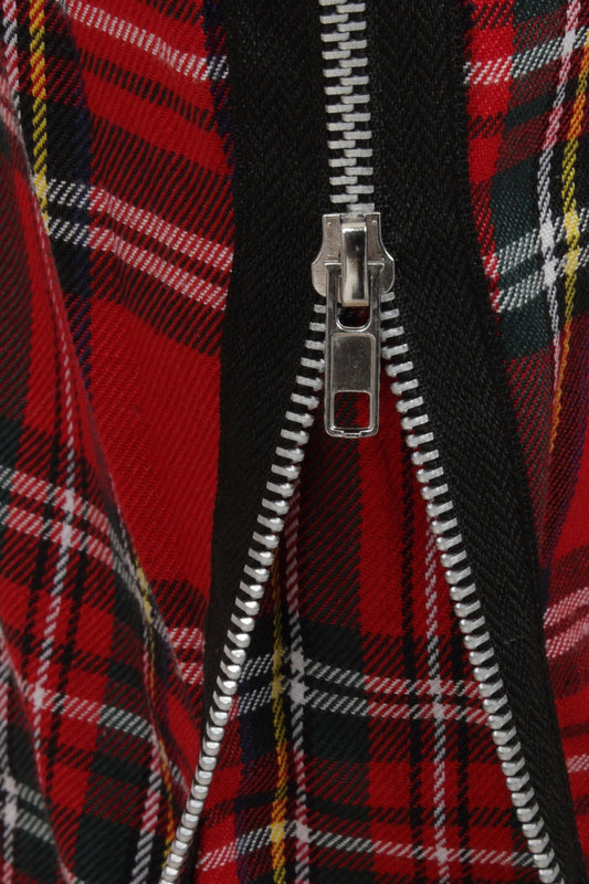 detail shot of zip feature on red tartan trousers