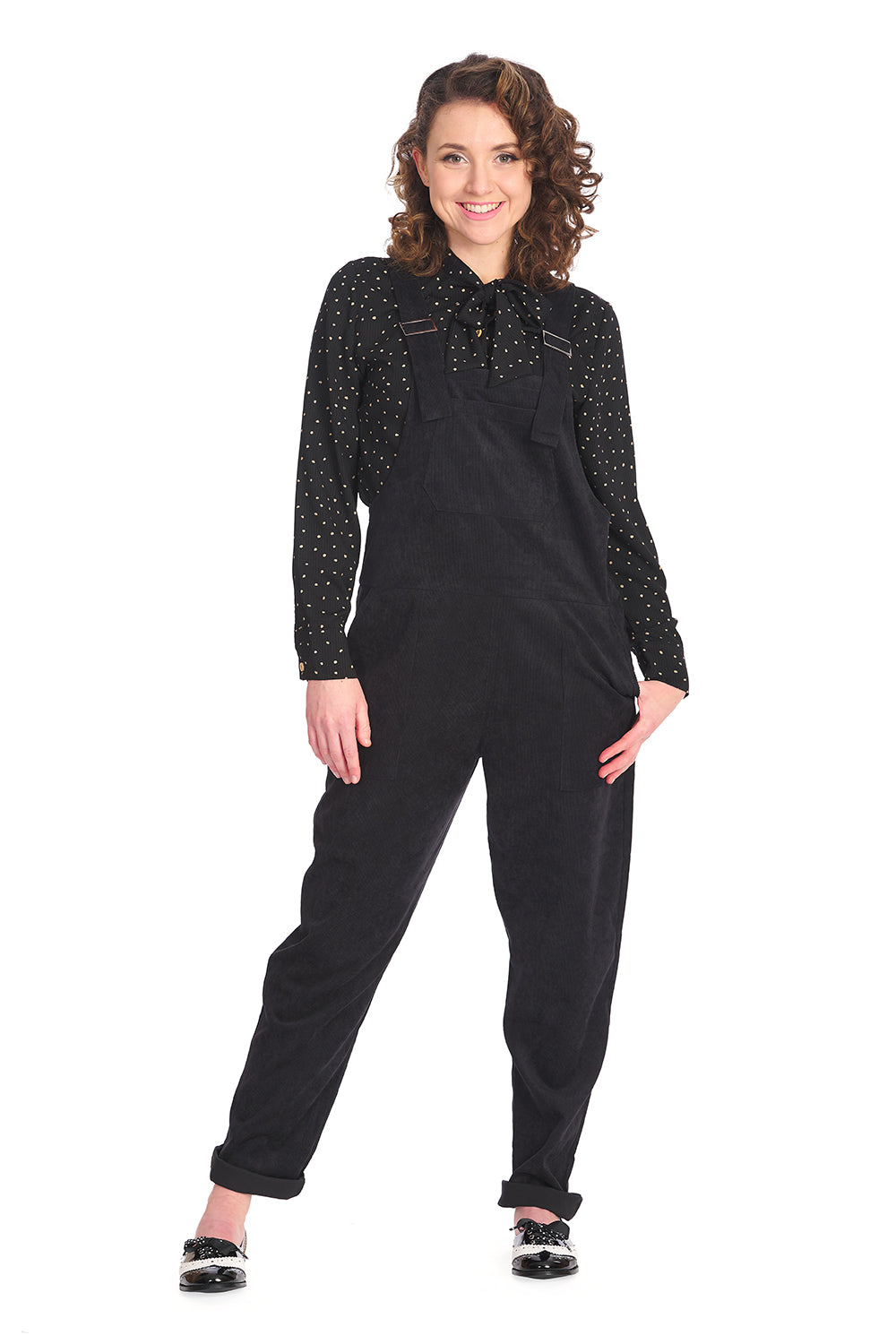 Retro model in black dungarees with black polka dot blouse