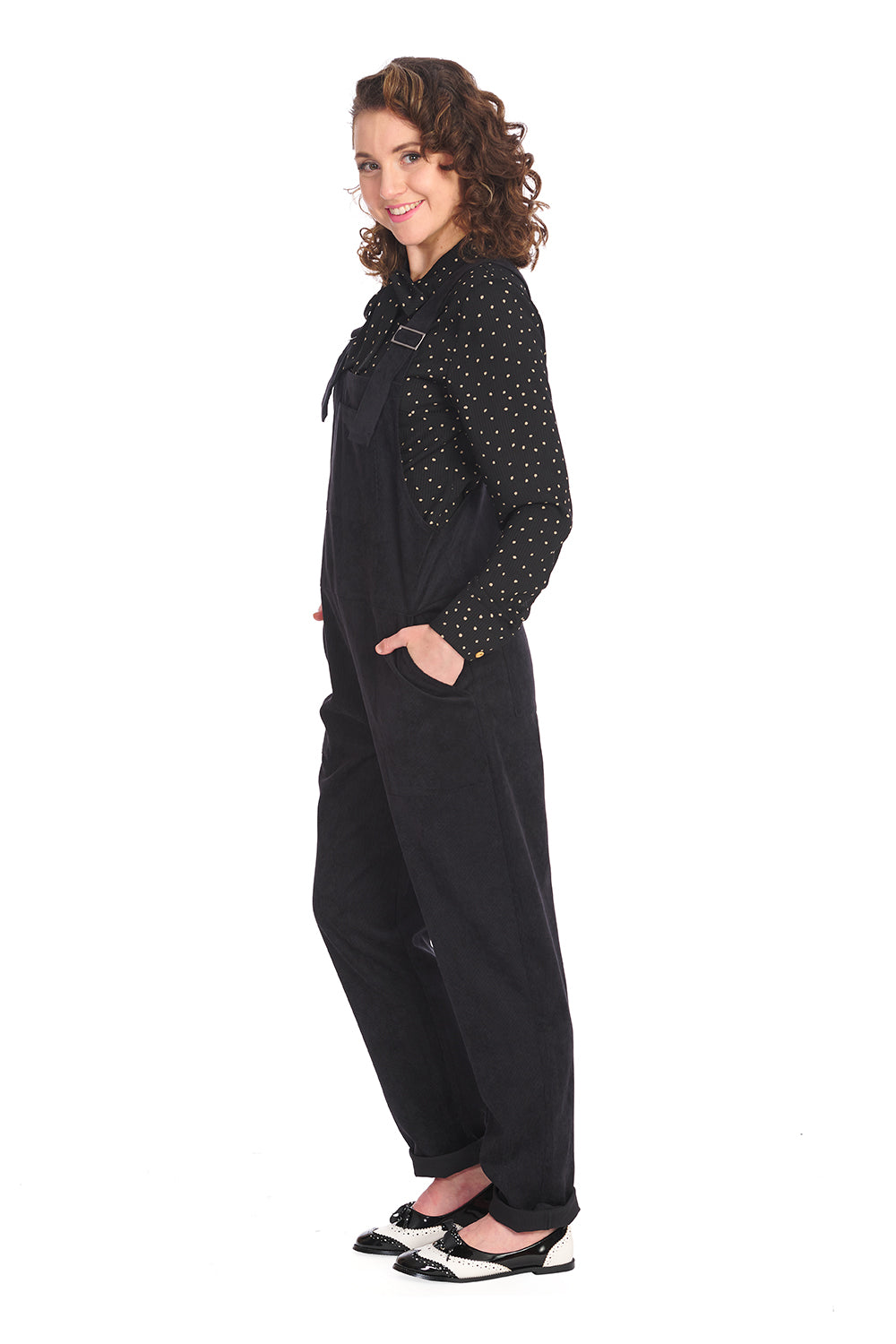 Retro model in black dungarees with black polka dot blouse