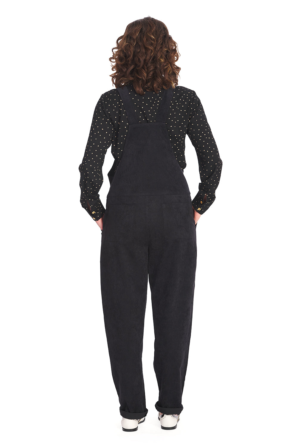 Retro model in black dungarees with black polka dot blouse