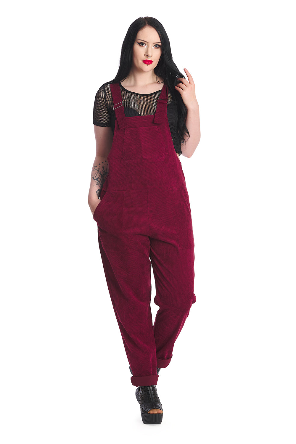 Gothic model in burgundy dungarees with a black mesh top