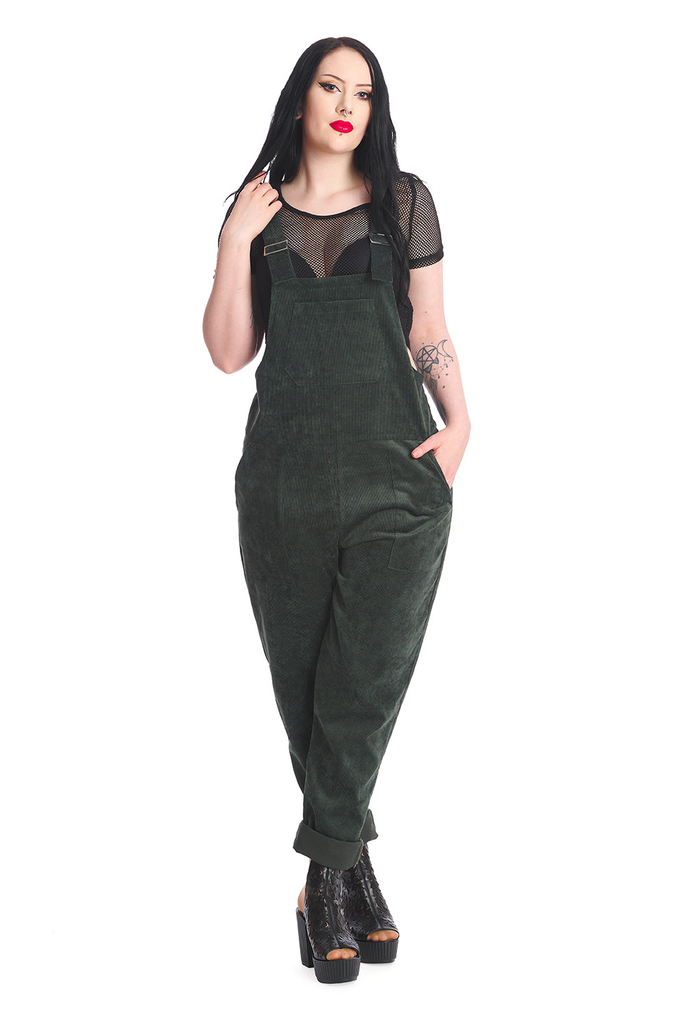 Gothic model in dark green dungarees with a black mesh top