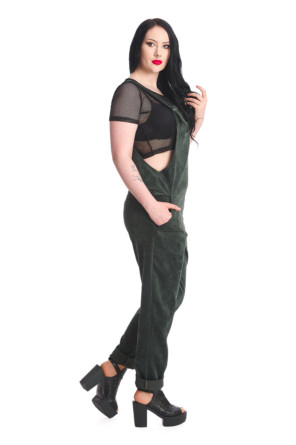 Gothic model in dark green dungarees with a black mesh top