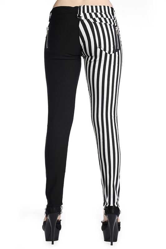 Low rise skinny jeans with one black leg and one black and white striped leg