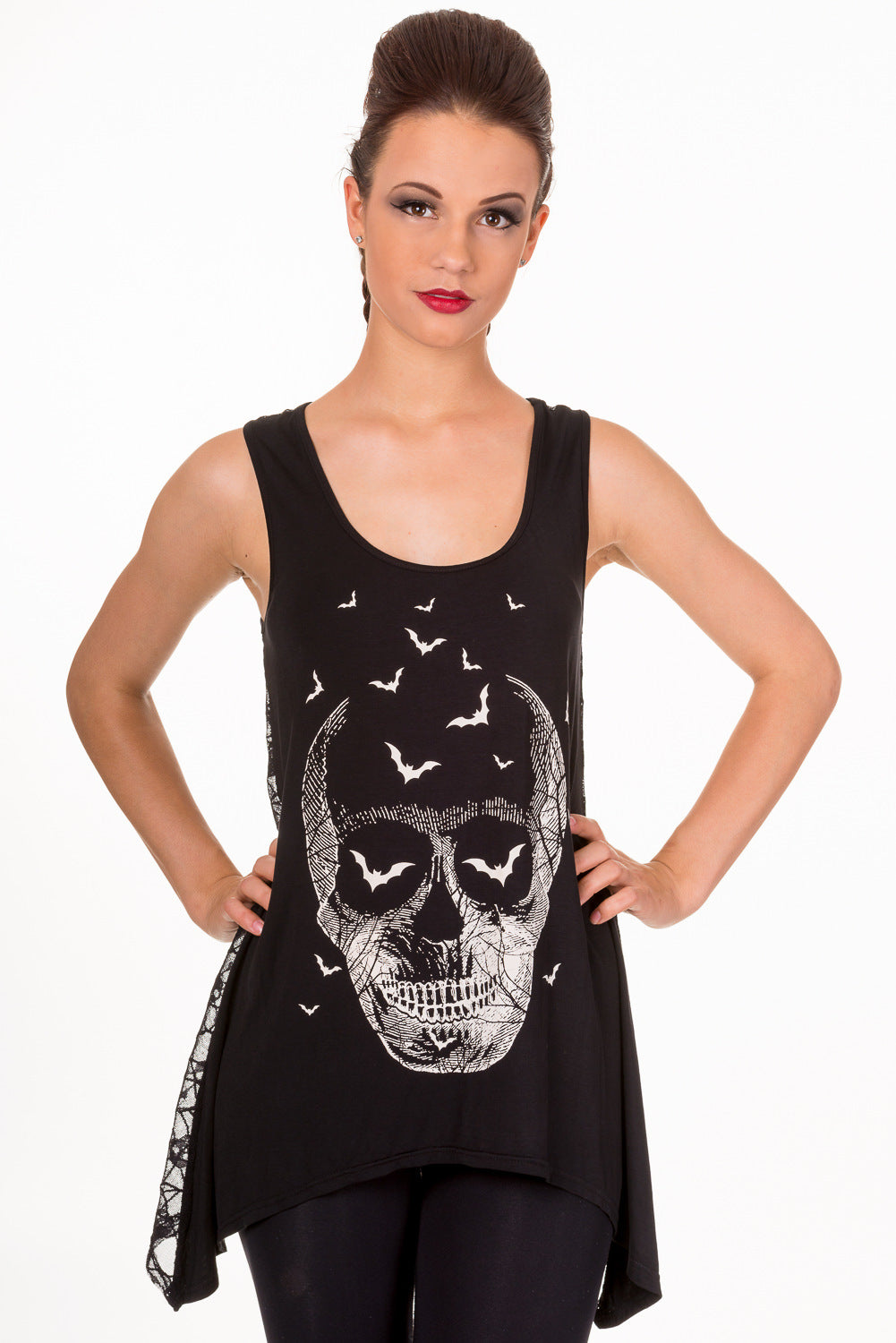 Model wearing long line black vest top with white skull print and bats 