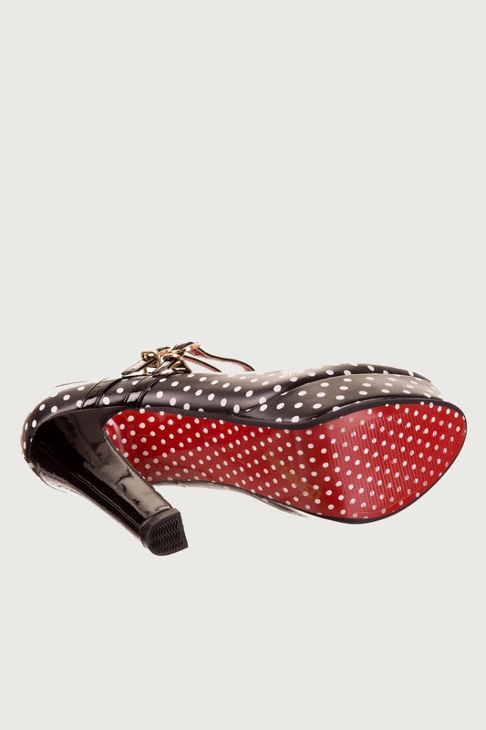 High heel black shoe with straps and white polka dot print and red polka dot sole