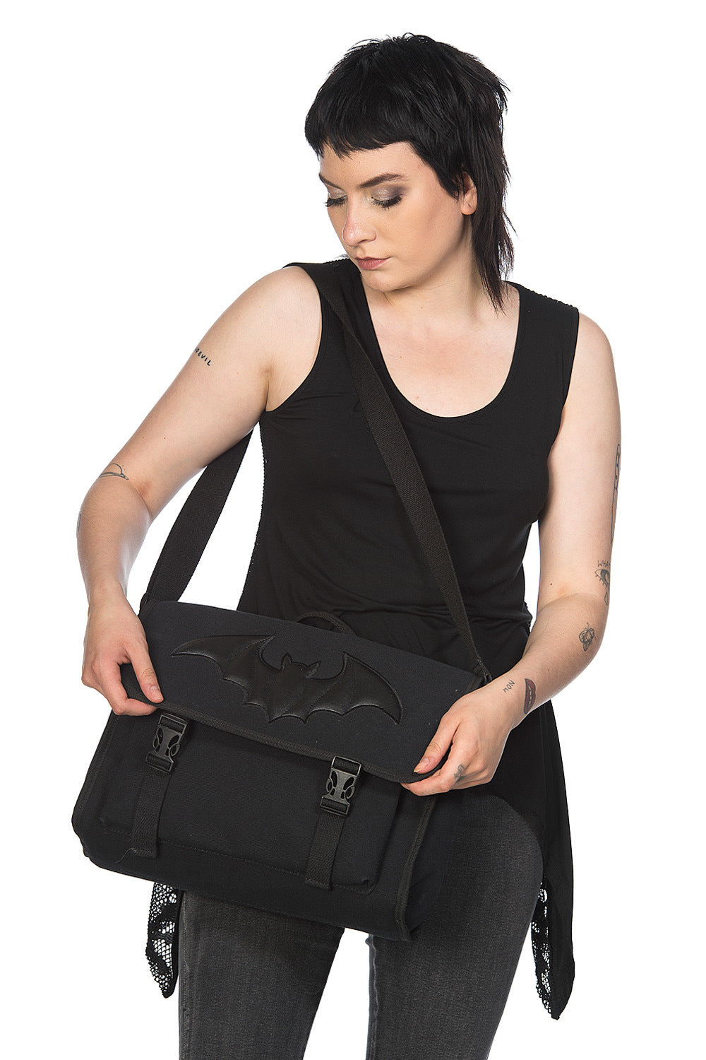 Alternative model holding Black shoulder bag with embossed bat motif 