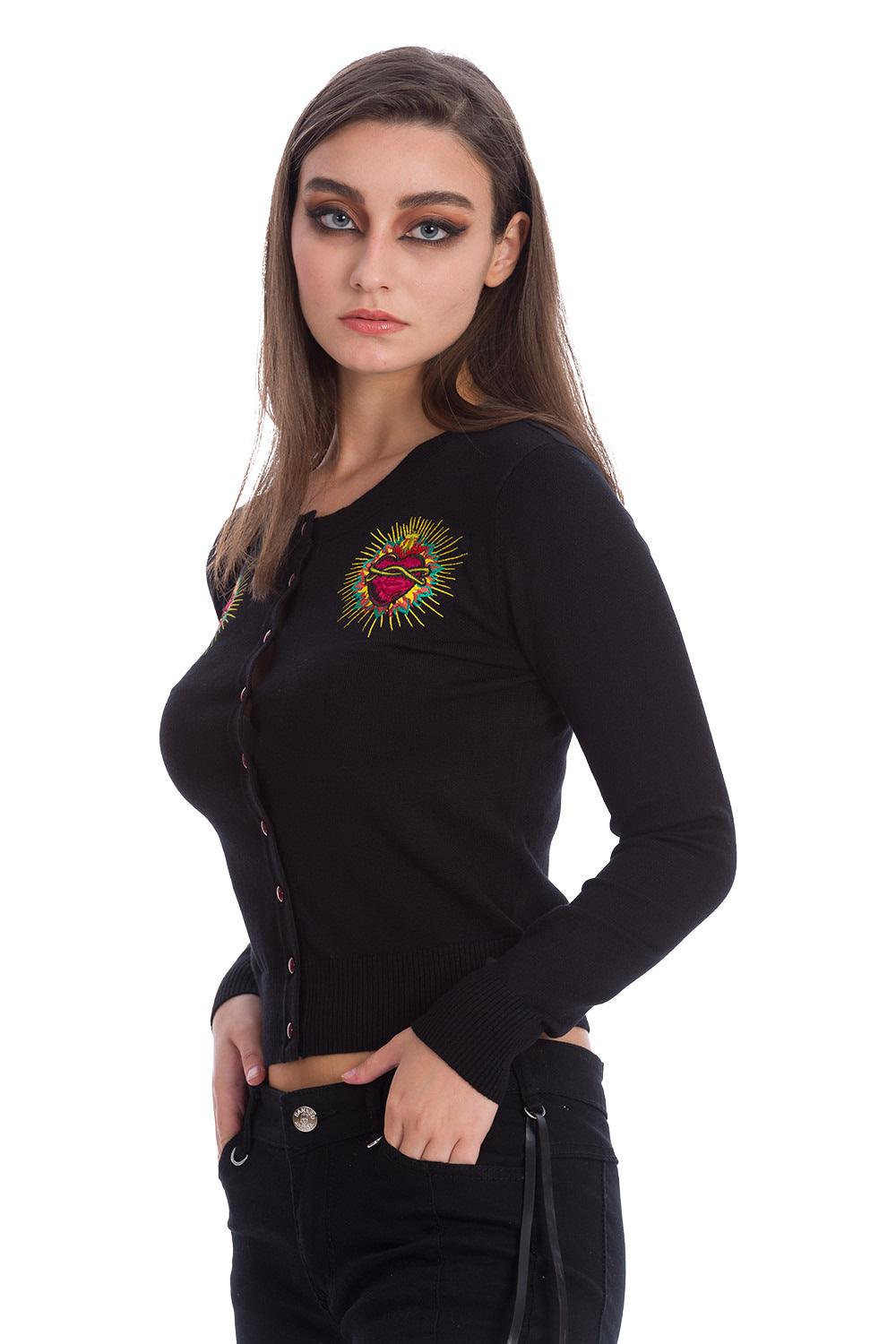 Model wearing a black cardigan with red buttons and heart shoulder motifs 
