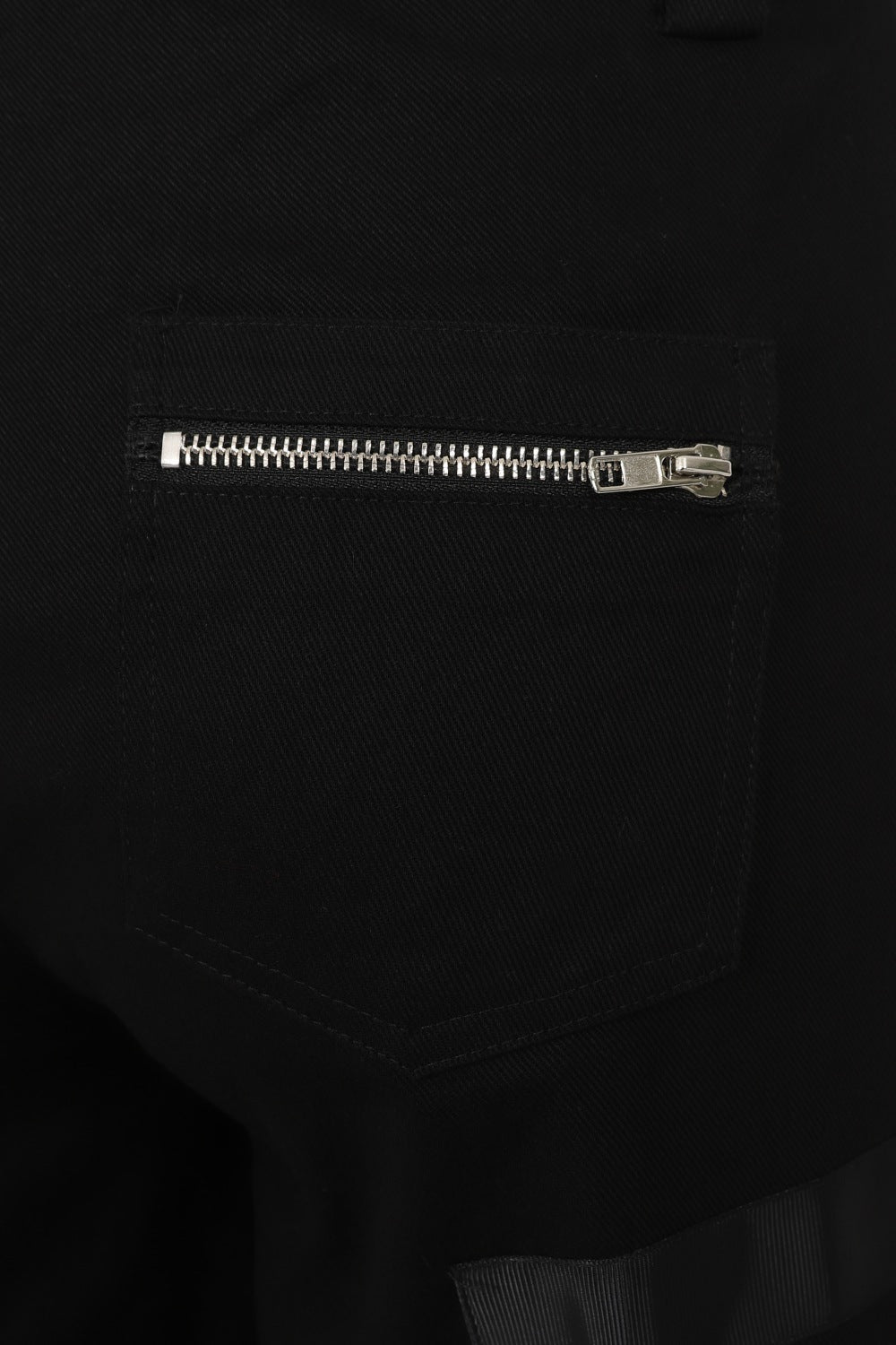 Baggy black trousers with zip and buckle features