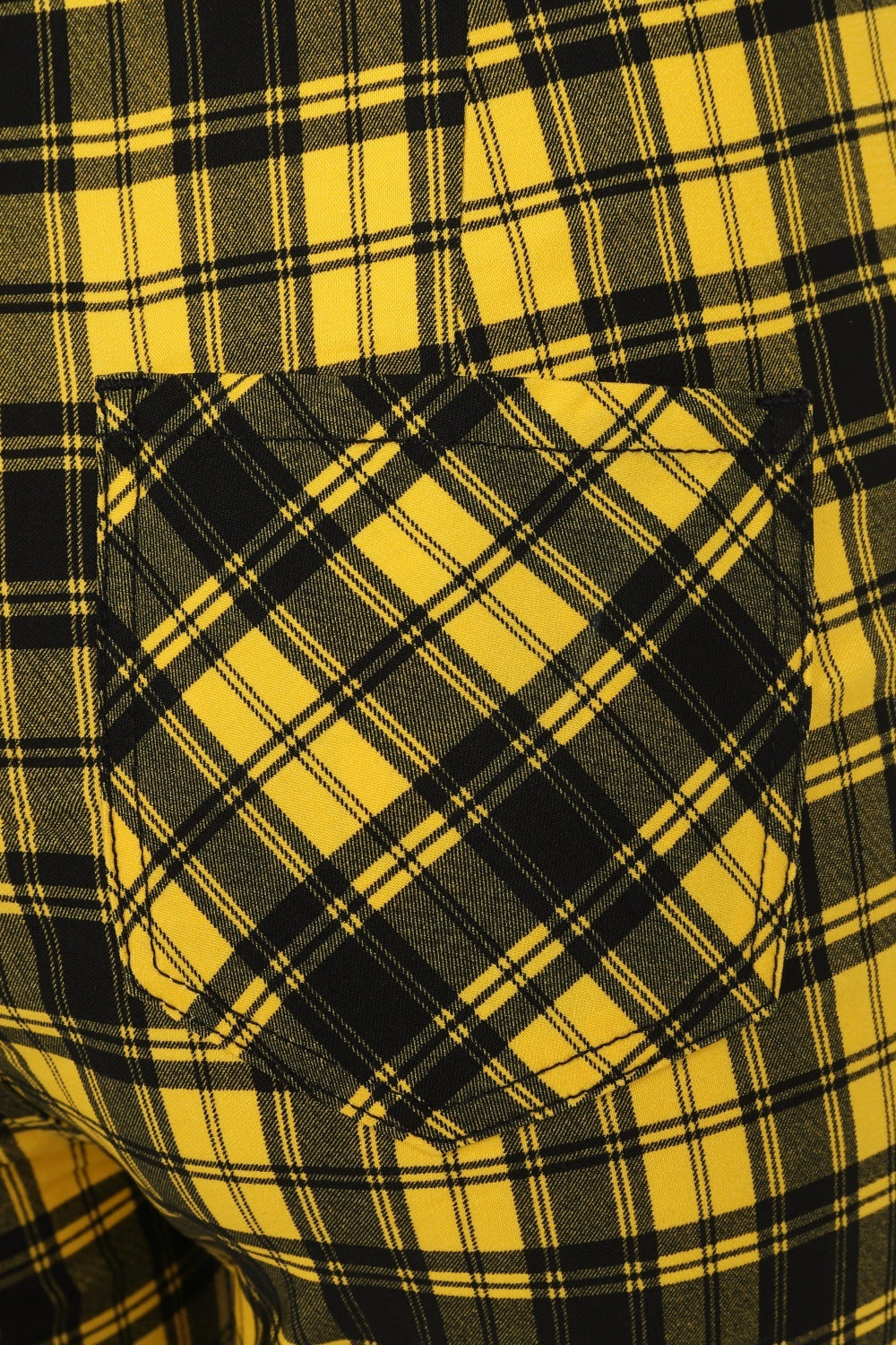 High waisted trousers in yellow tartan with zip front and pentagram zip details
