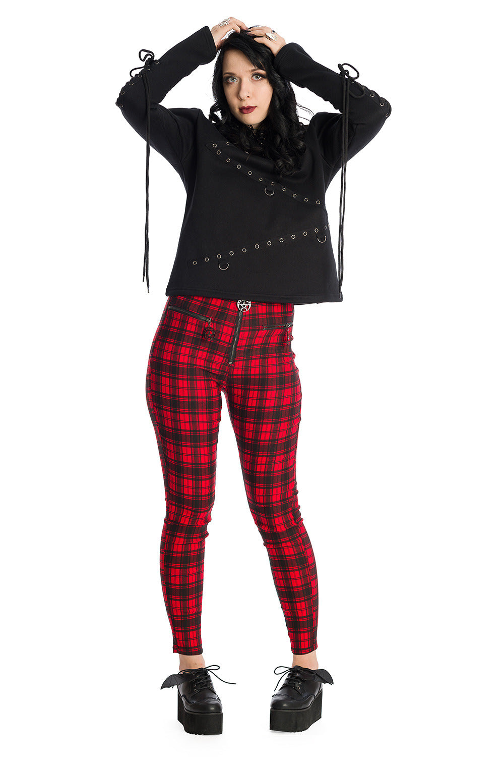 Grunge model in red tartan trousers with black buckle long sleeve top 