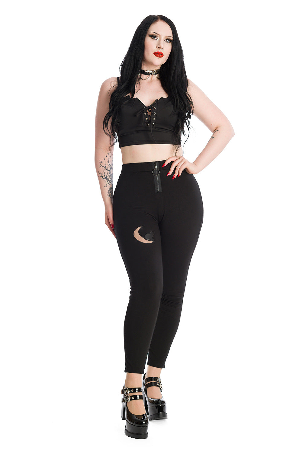 Alternative model in black crop top with corset detail and high waisted leggings with moon mesh detailing