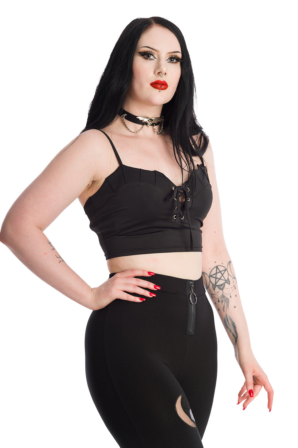 Alternative model in black crop top with corset detail and high waisted leggings with moon mesh detailing