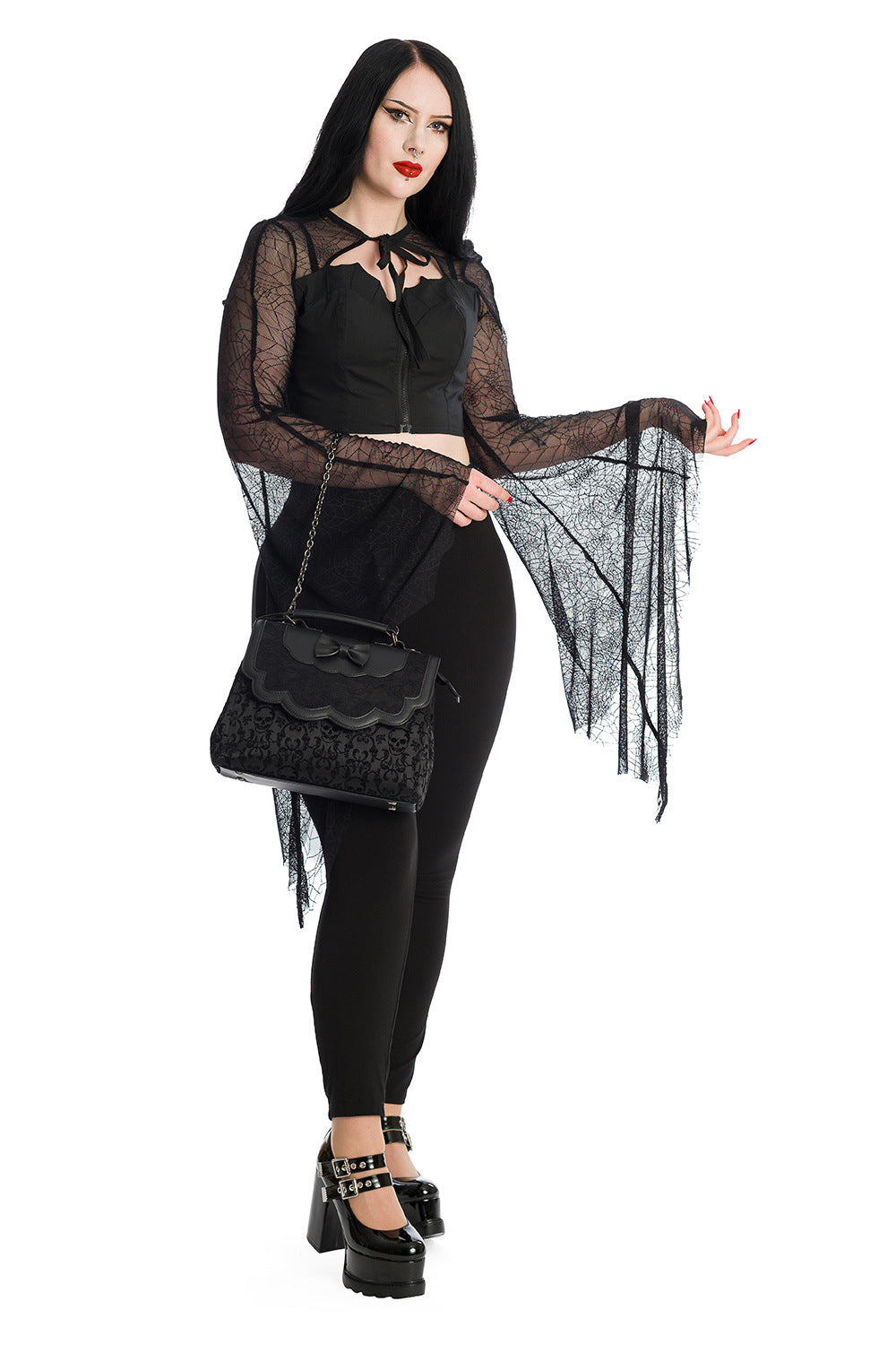 Alternative model wearing a gothic bat wing lace sleeved crop top with high waisted leggings with lace handbag