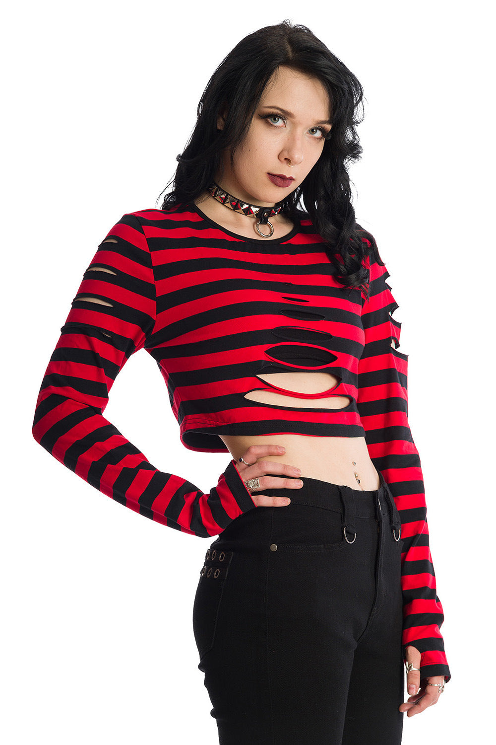 Alternative model wearing red striped cropped top with long sleeves, rips and thumb holes 