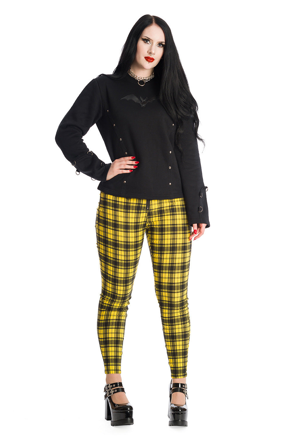 Gothic model in yellow tartan trousers with black bat long sleeve top 