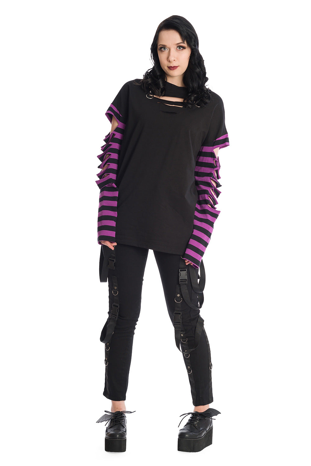 Alternative model in oversized, long sleeve striped top with Skinny fit trousers with straps and buckle features 