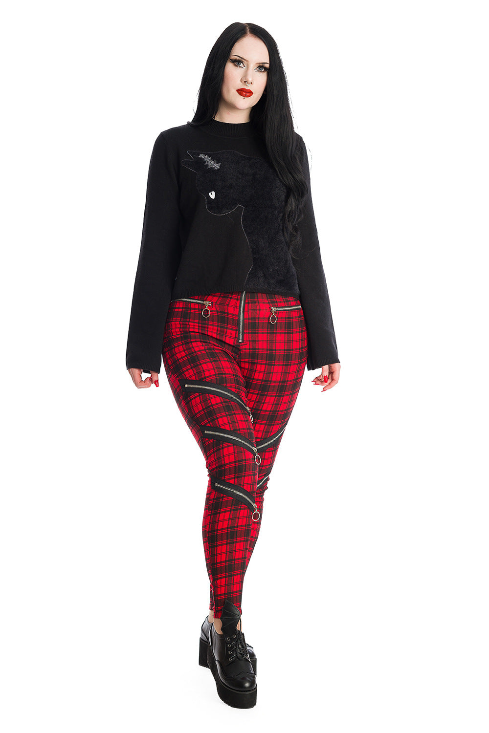 Model wear black jumper with black cat and High waisted red check trousers with zip details on legs 