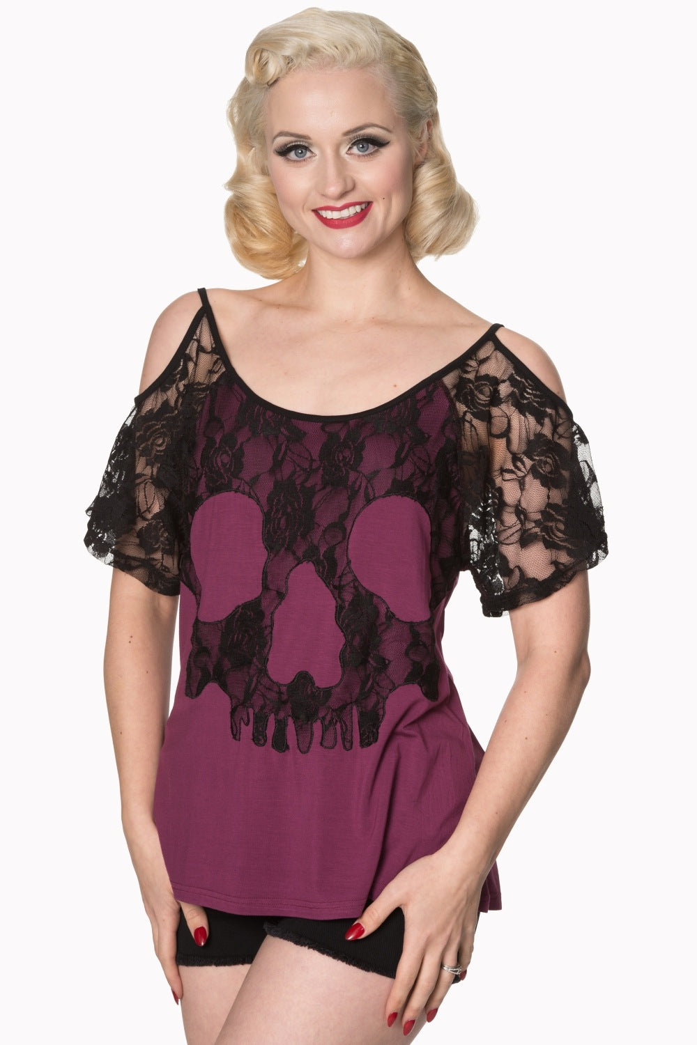 Model wearing lace top with skull detail in purple