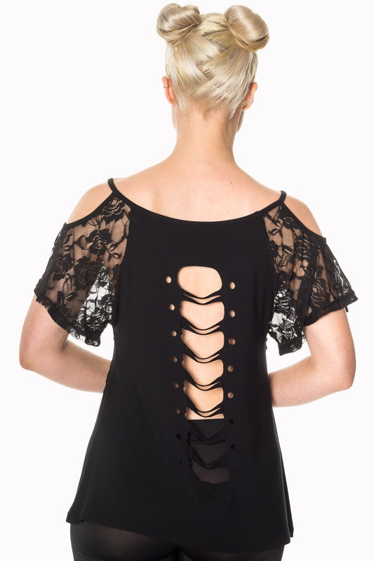 Model wearing lace top with skull detail in black showing rips on back