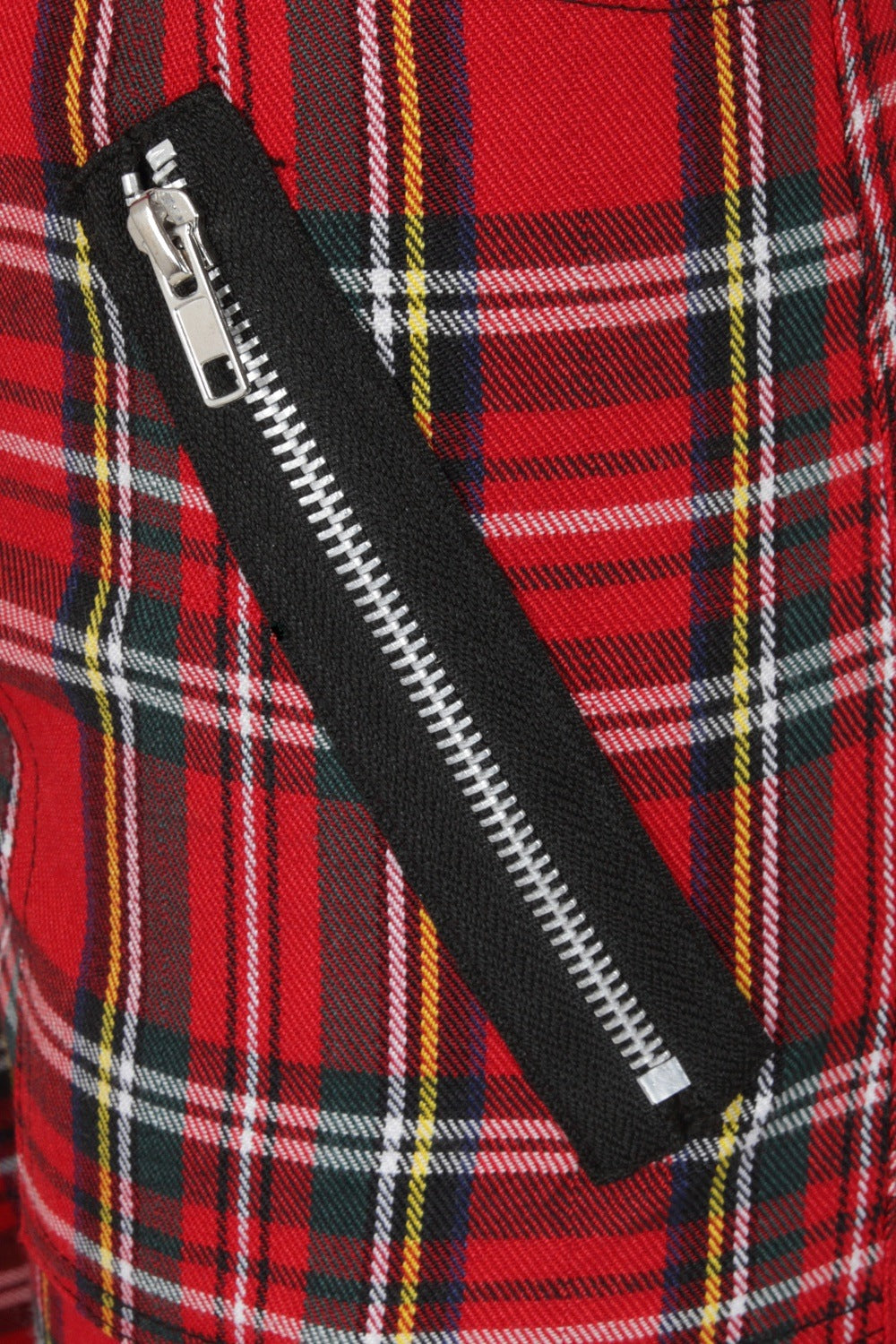 detail shot of zip feature on red tartan trousers