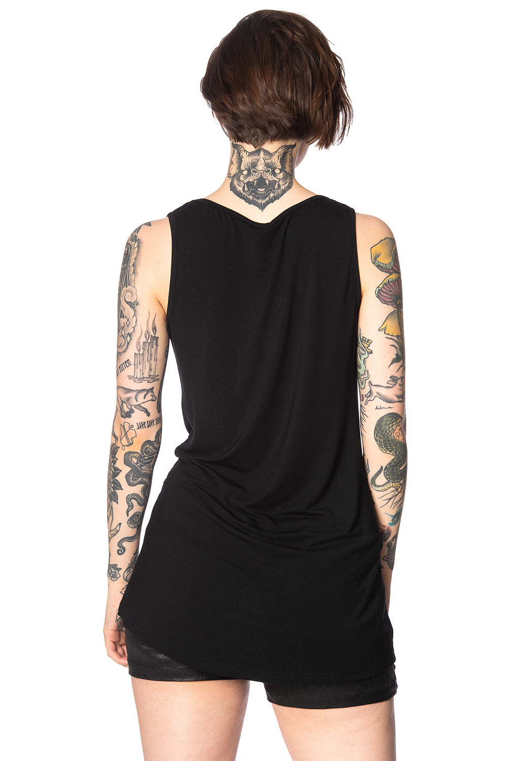 Alternative model with tattoos wears black outfit with movie poster print vest top