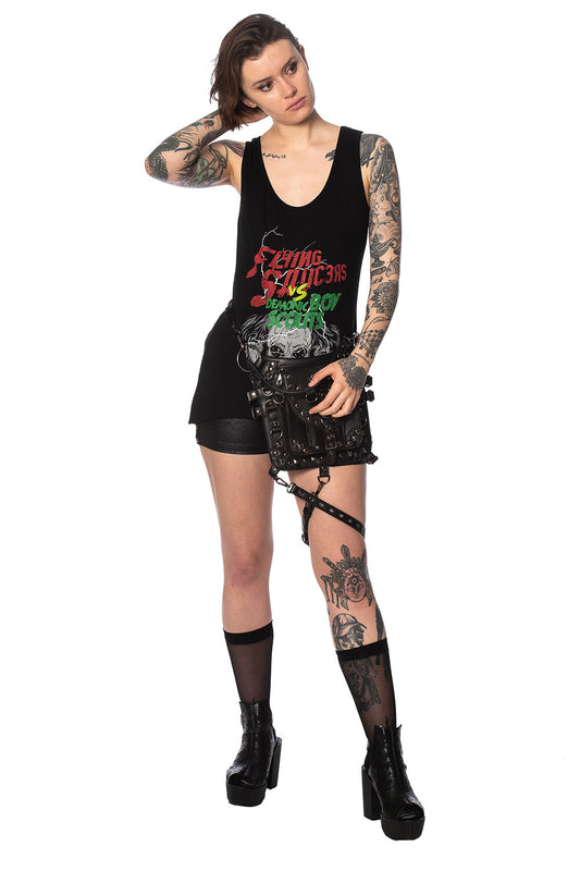 Alternative model with tattoos wears black outfit with movie poster print vest top