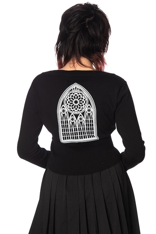 Model shows back of black cardigan showing cathedral motif