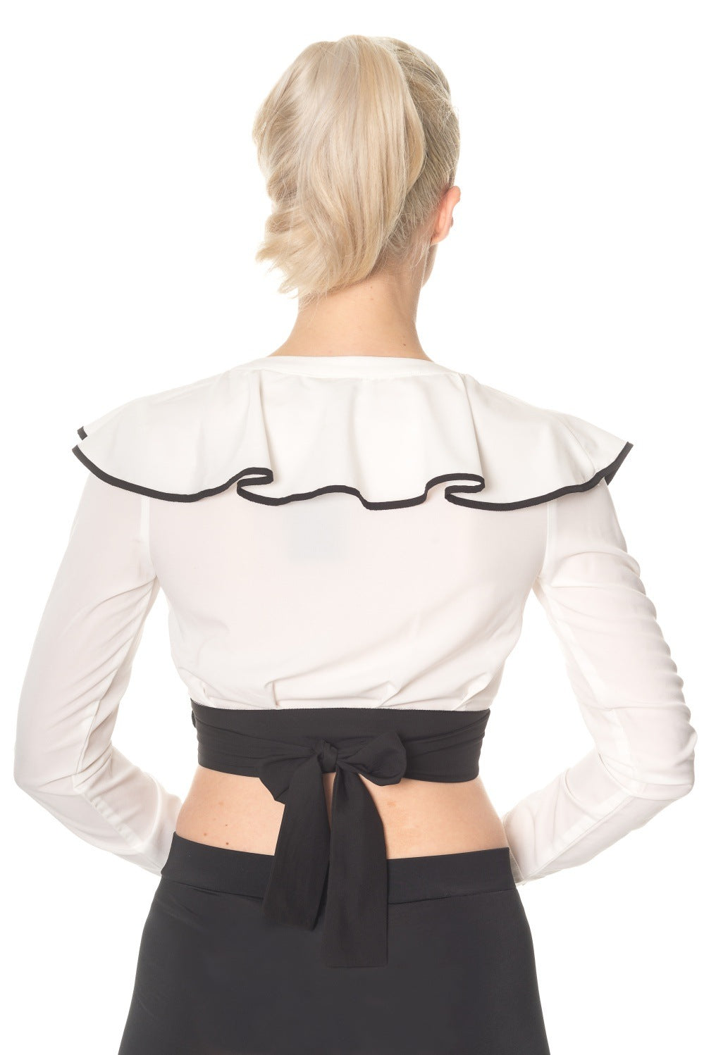 Vintage model wears crop wrap top in white with frills and black trim 