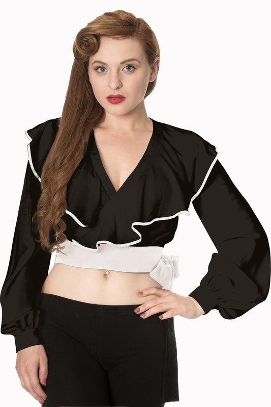 Vintage model wears crop wrap top in black with frills and white trim