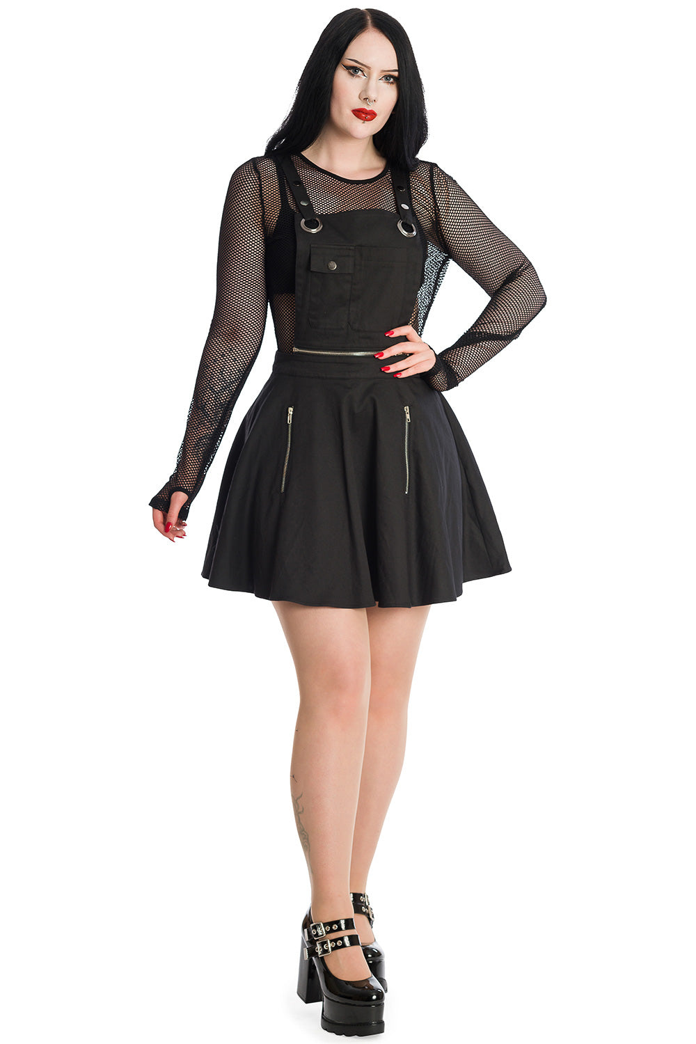 Gothic model in black pinafore dress with mesh long sleeve top