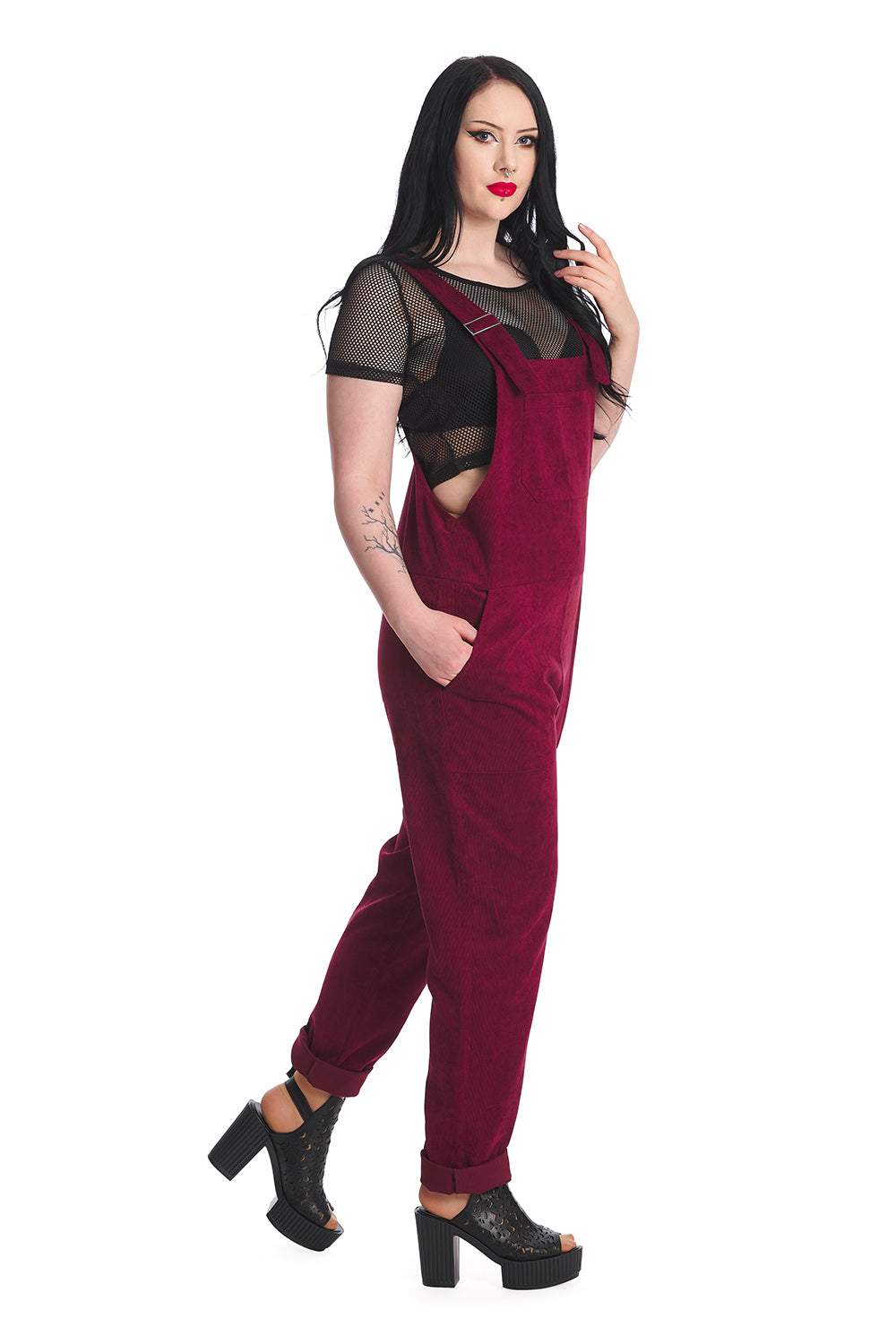 Gothic model in burgundy dungarees with a black mesh top 