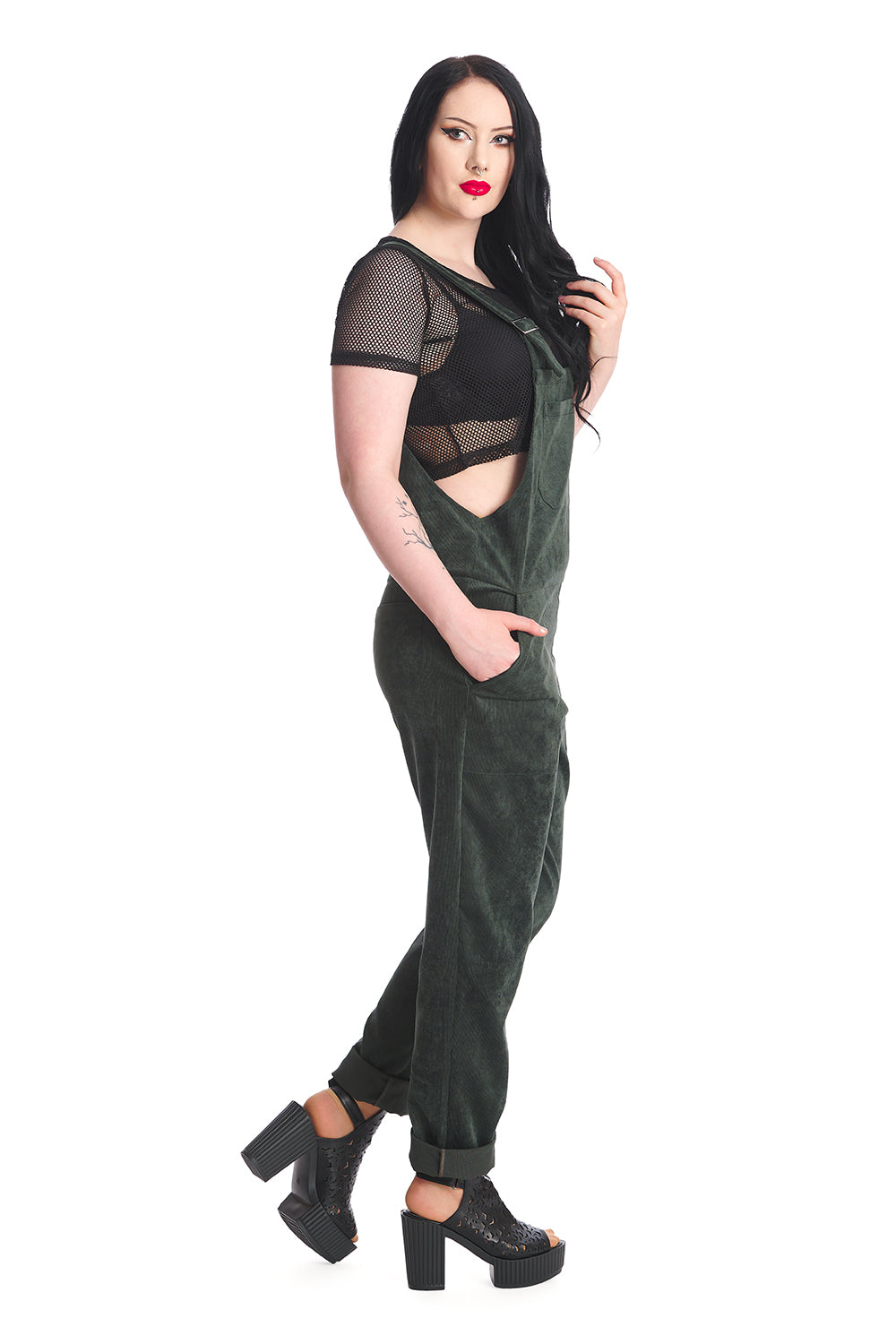 Gothic model in dark green dungarees with a black mesh top 