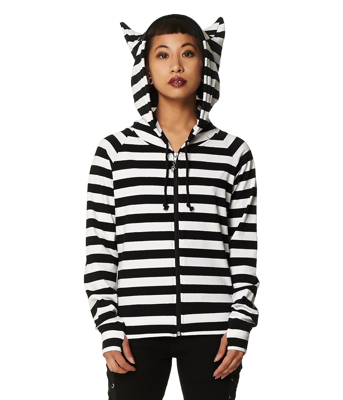 Model wearing a black and white  stripes zip up hoodie with cat ears on the hood and thumb holes in the sleeves